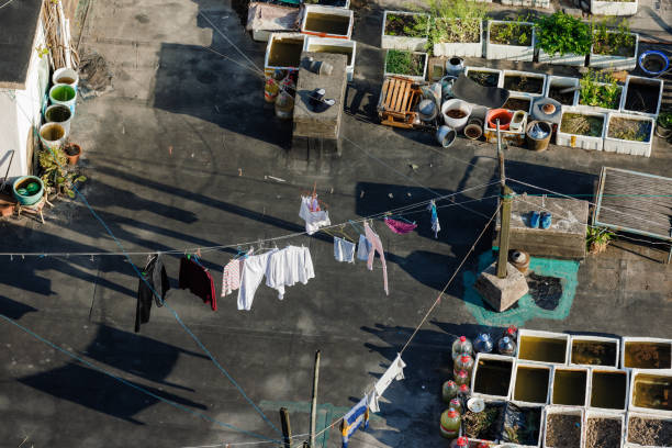 April 6th, 2022, China, Shanghai - Some clothes hanging on a clothesline on a rooftop, surrounded by a rooftop garden. For a few lucky ones the rooftop is the only escape outside during the lockdown in Shanghai.