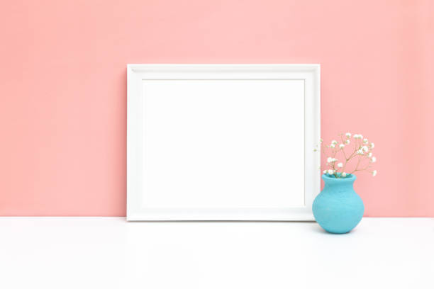 istock White horizontal wooden frame mockup with small vase and white flower 1392693227