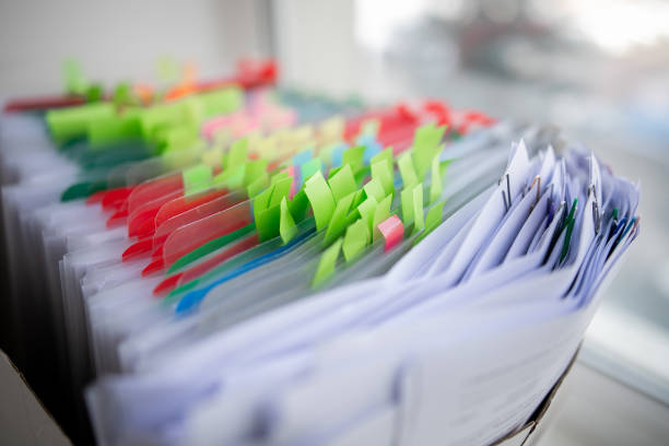 istock Pile of unfinished documents on office desk, Stack of business paper 1392693349