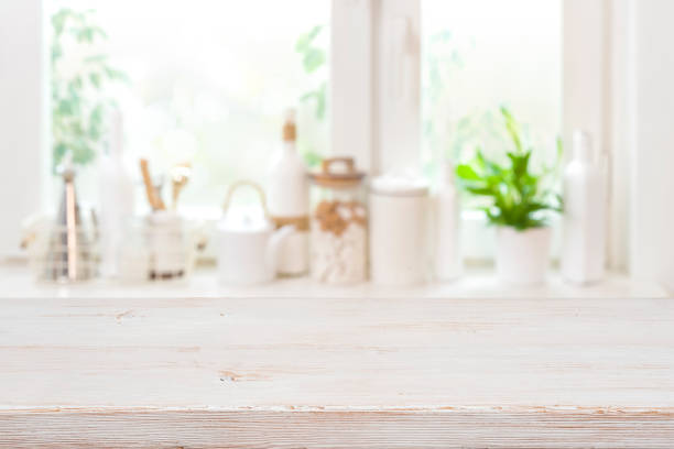 istock Wooden table over blurred kitchen window sill with food ingredients 1392696099