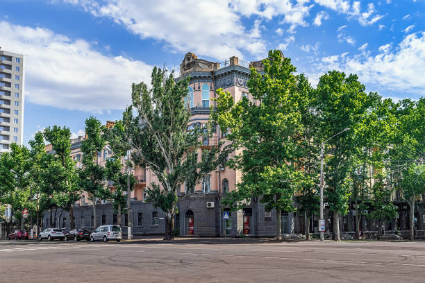 A beautiful old building among green trees at the corner of Soborna and Admiralska streets in Mykolaiv stock photo