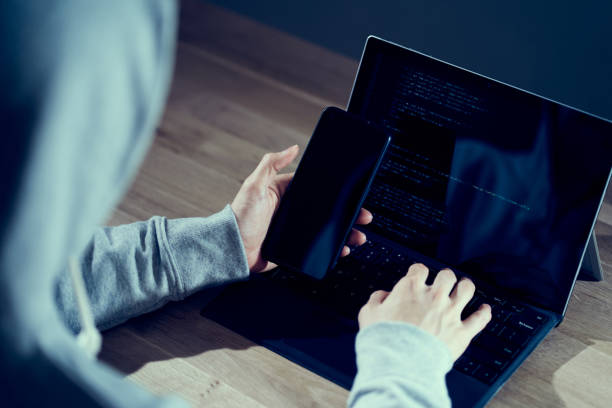 istock A male hacker checking the operation on a smartphone 1392696176