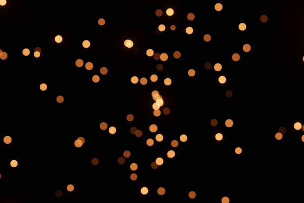 istock Defocused bokeh lights on black background, an abstract naturally blurred backdrop 1392697416