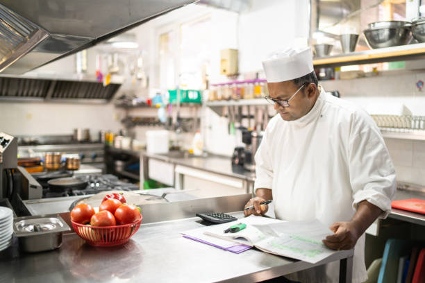 istock A chef checking the invoices and finances in the kitchen 1392698900