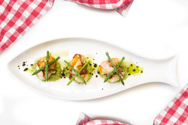 istock Mediterranean cuttlefish egg appetizer with asparagus on a white plate isolated 1392700083