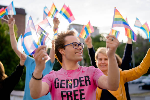 istock People with different LGBTQ+ flag protesting for huma rights on a pride event 1392701294