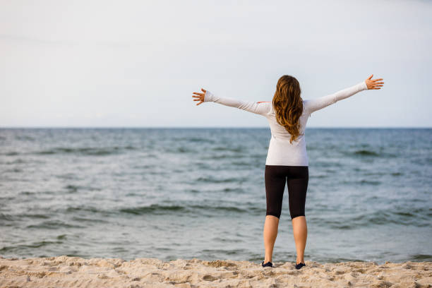 istock Young woman walking at seaside 1392701397
