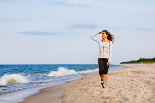 istock Young woman walking at seaside 1392701413
