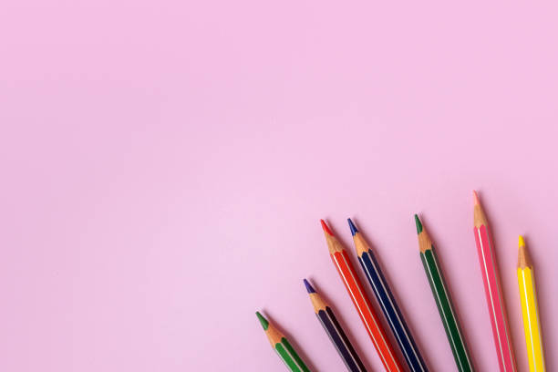 istock Color pencils on a light pink background. Top view with space for text 1392702205