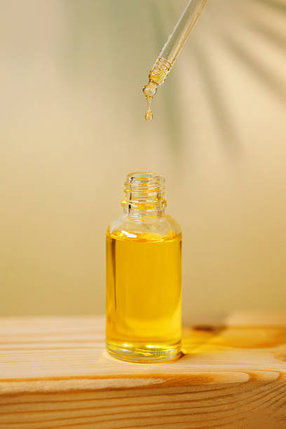 istock Front view of amber colored essential oil bottle with pipette 1392702226