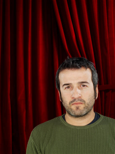 istock Thoughtful man in front of the red curtain 1392702562