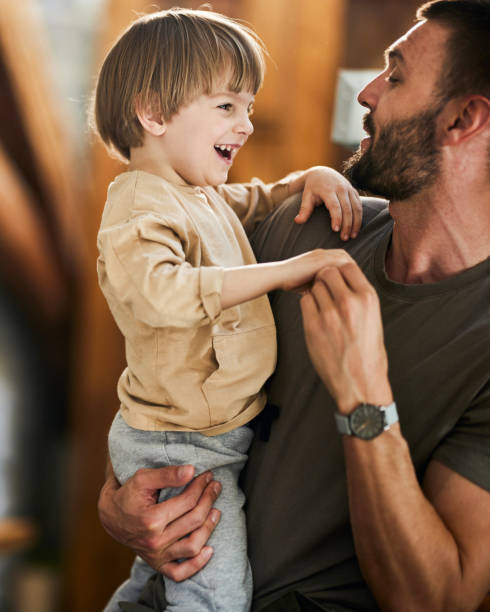 istock Happy boy having fun with his single father at home. 1392706392