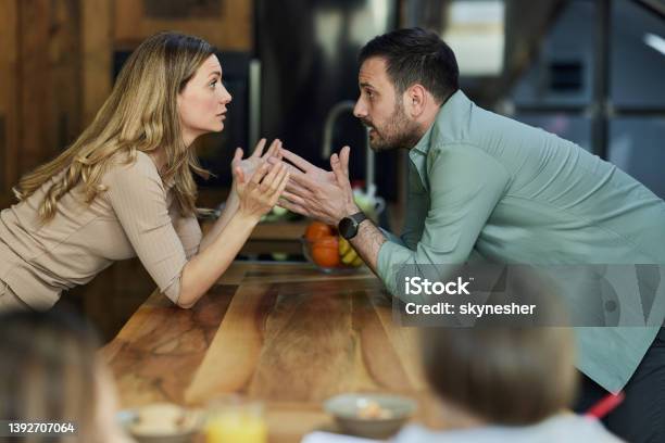 Young Couple Having An Argument At Home Stock Photo - Download Image Now - Couple - Relationship, Two Parents, Arguing