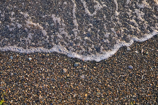 Sea wave on a pebble beach
