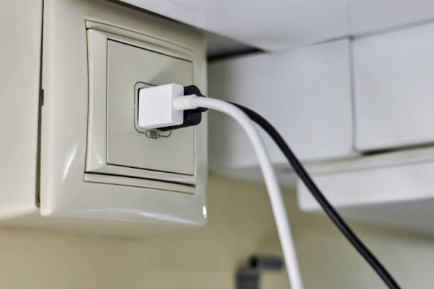istock Two plugs for charging smartphones are inserted into a special charger socket in a compartment car of a passenger train 1392708168