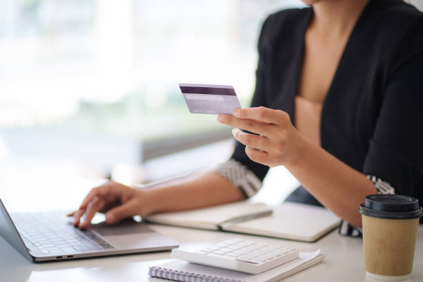 istock Woman using shopping web site by laptop computer and payment by credit card. 1392709355