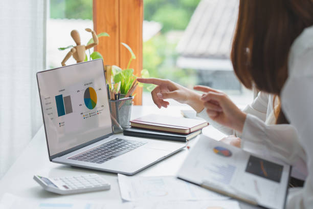 istock Group of IT consultant working by laptop computer and management big data and analyze financial document of company. 1392710164