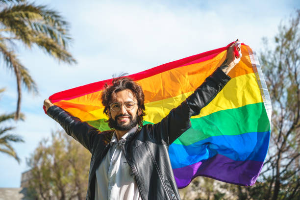 istock transgender person with LGBT flag 1392712011