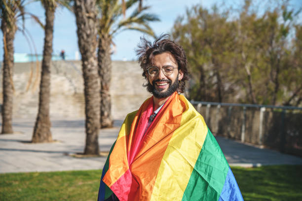 istock Positive man wrapped in LGBT flag 1392712692