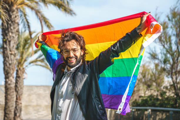 istock transgender person with LGBT flag 1392712742