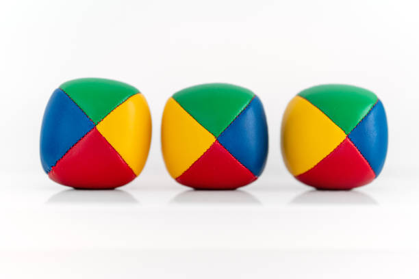 istock Three colorful juggling balls against white background 1392714408