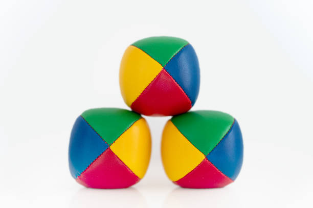 istock Three colorful juggling balls against white background 1392714419