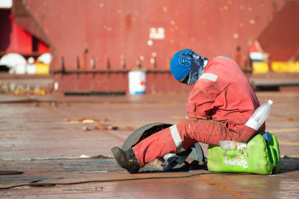 5th October, 2025 - Port workers attaching a securing rope from a cruise ship to bollards on the harbour quay in Getxo, Northern Spain