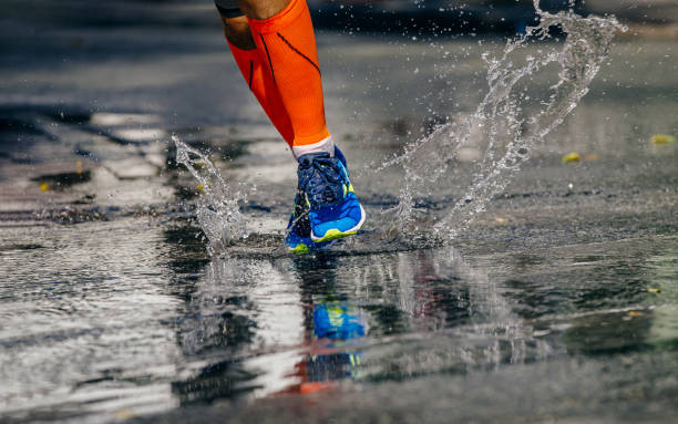 istock legs male athlete running puddle 1392715831
