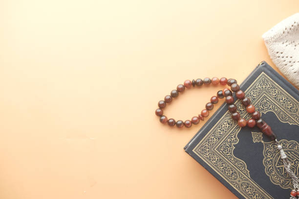 istock Holy book Quran and rosary on table, close up. 1392717099