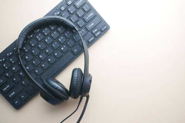 istock call center headphone on laptop on table , 1392717449