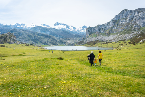 Grandmother, mother and son sightseeing at Lake Ercina in the Lakes of Covadonga. Asturias. Spain