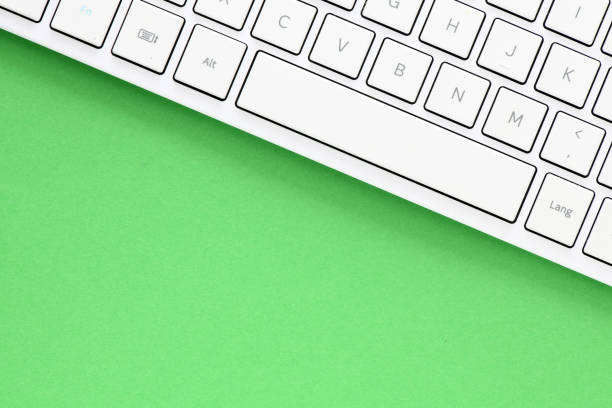 istock Close up white computer keyboard on green background. View from above. 1392719152