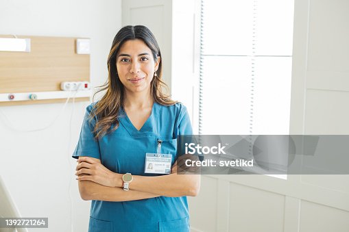 istock Portrait of female nurse at medical clinic. 1392721264