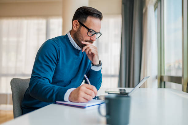 istock Thoughtful entrepreneur planning strategy while working on laptop at office desk 1392721539