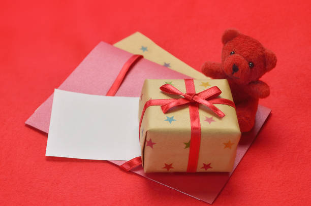 istock Teddy Bear, Gift Box & Greeting Card on the Red Background 1392724441
