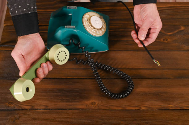 istock concept of no connection. a wired phone and a broken wire. 1392727538