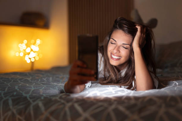 istock Woman using smart phone in bed 1392728766