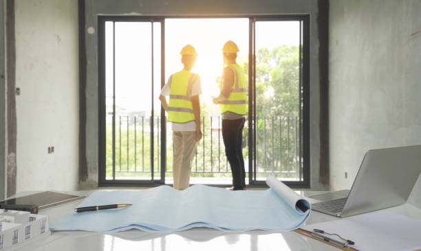 istock A group of workers, a designer team talk, communicate, discuss, and work in meeting room on construction site, present ideas to colleagues. People lifestyle. Corporation. Men 1392732453