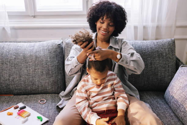 istock Mother Tying Her Daughter's Hair 1392735657