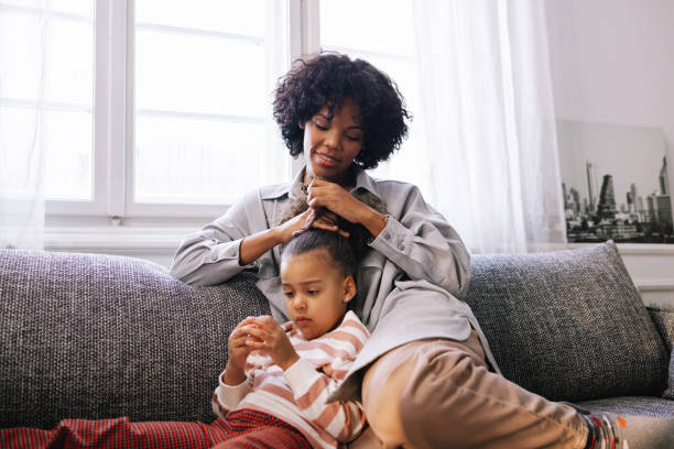 istock Mother Tying Her Daughter's Hair 1392735661