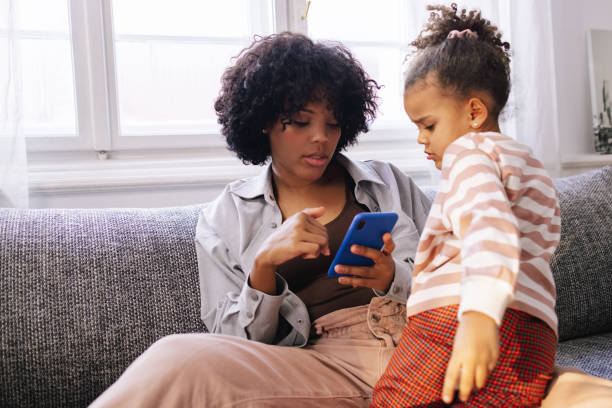 istock Mother And Daughter Using A Smartphone 1392735668