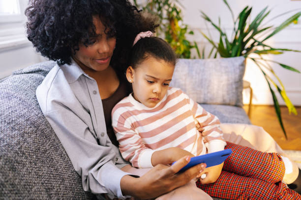 istock Mother And Daughter Using A Smartphone 1392735669