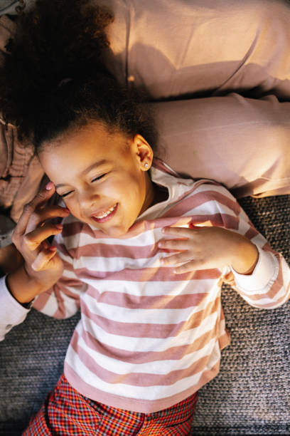 istock Daughter Lying In Her Mother's Lap 1392735673