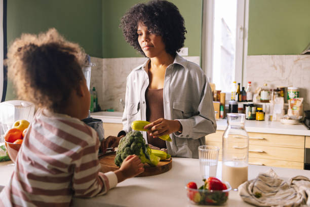istock Mother And Daugther Preparing A Meal Together 1392735695