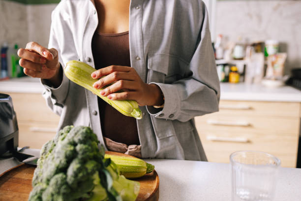 istock Anonymous Woman Holding A Zucchini 1392735699