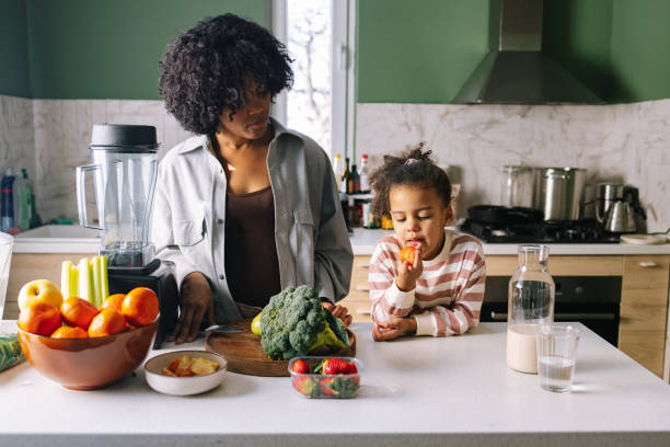 istock Mother And Daughter Preparing A Meal Together 1392735702