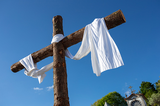 Wooden Cross with a white tissue during the Holy Week of 2022 in Porto de Ave Sanctuary, Povoa de Lanhoso, Braga, Portugal.