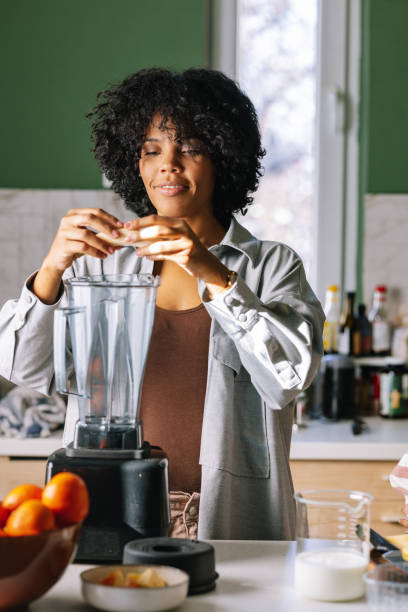 istock Afro-American Woman Using Blender 1392735707