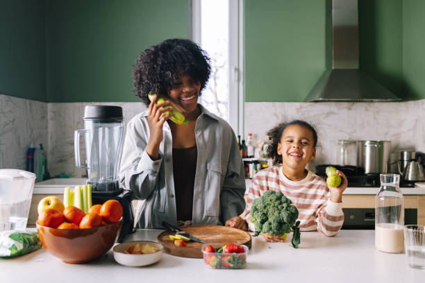 istock Mother And Daughter Playing With Vegetables 1392735710