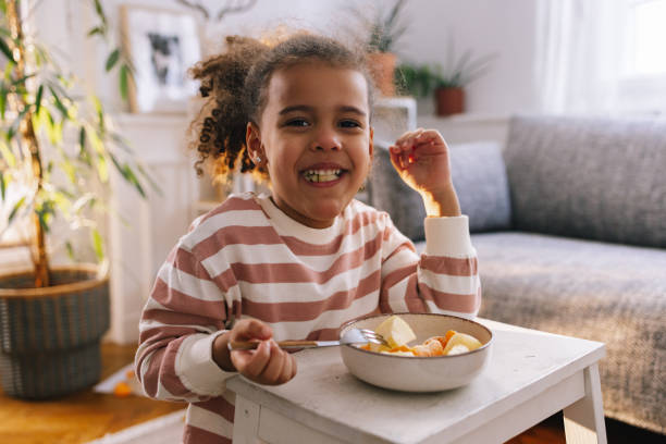 istock Afro-American Child Eating Fruit 1392735711